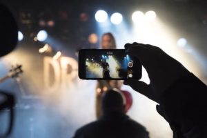 Person at live concert recording it on their phone
